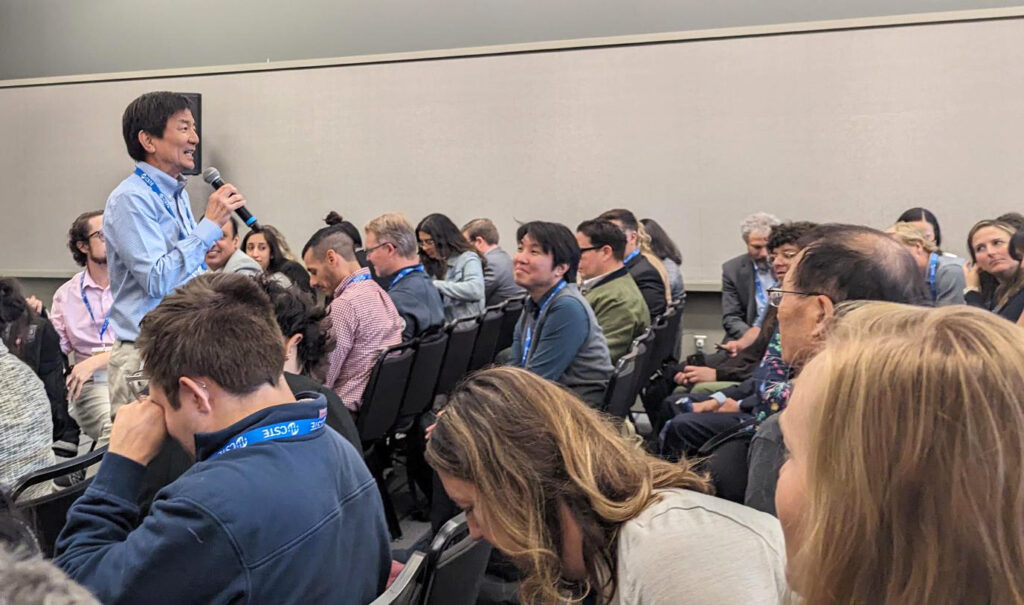 Man addressing a conference crowd