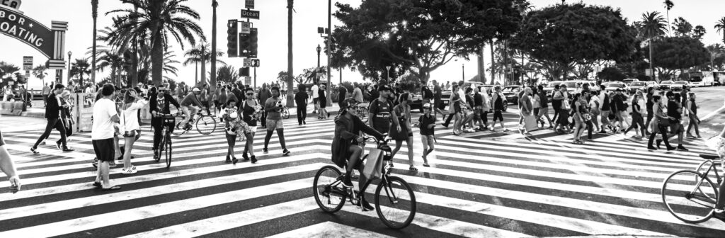 People walking and biking in a busy LA intersection