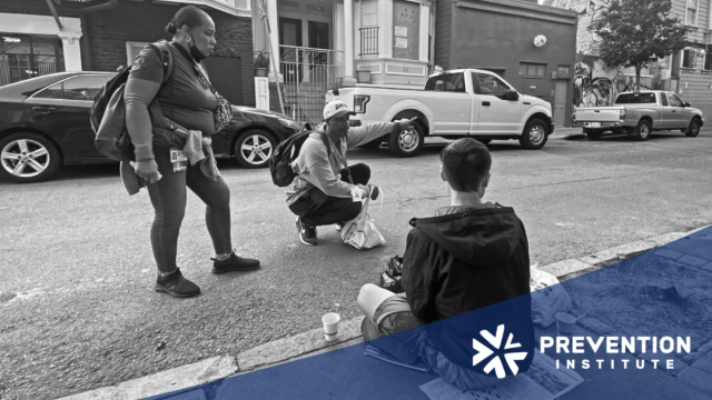 Graphic showing two public health workers talking with a man sitting on a city street.