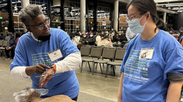 Health worker demonstrating how to care for someone who has overdosed